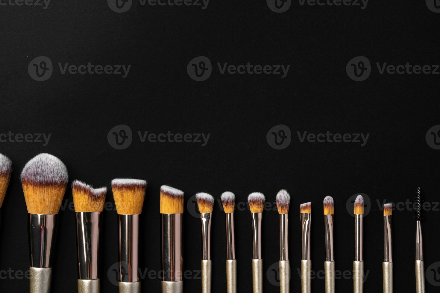 Collection of make up brushes on black background photo