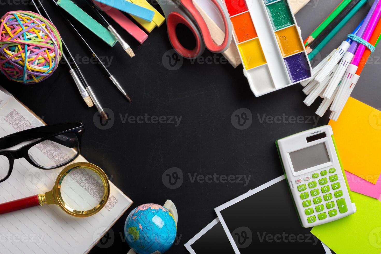 Desk of an artist with lots of stationery objects photo