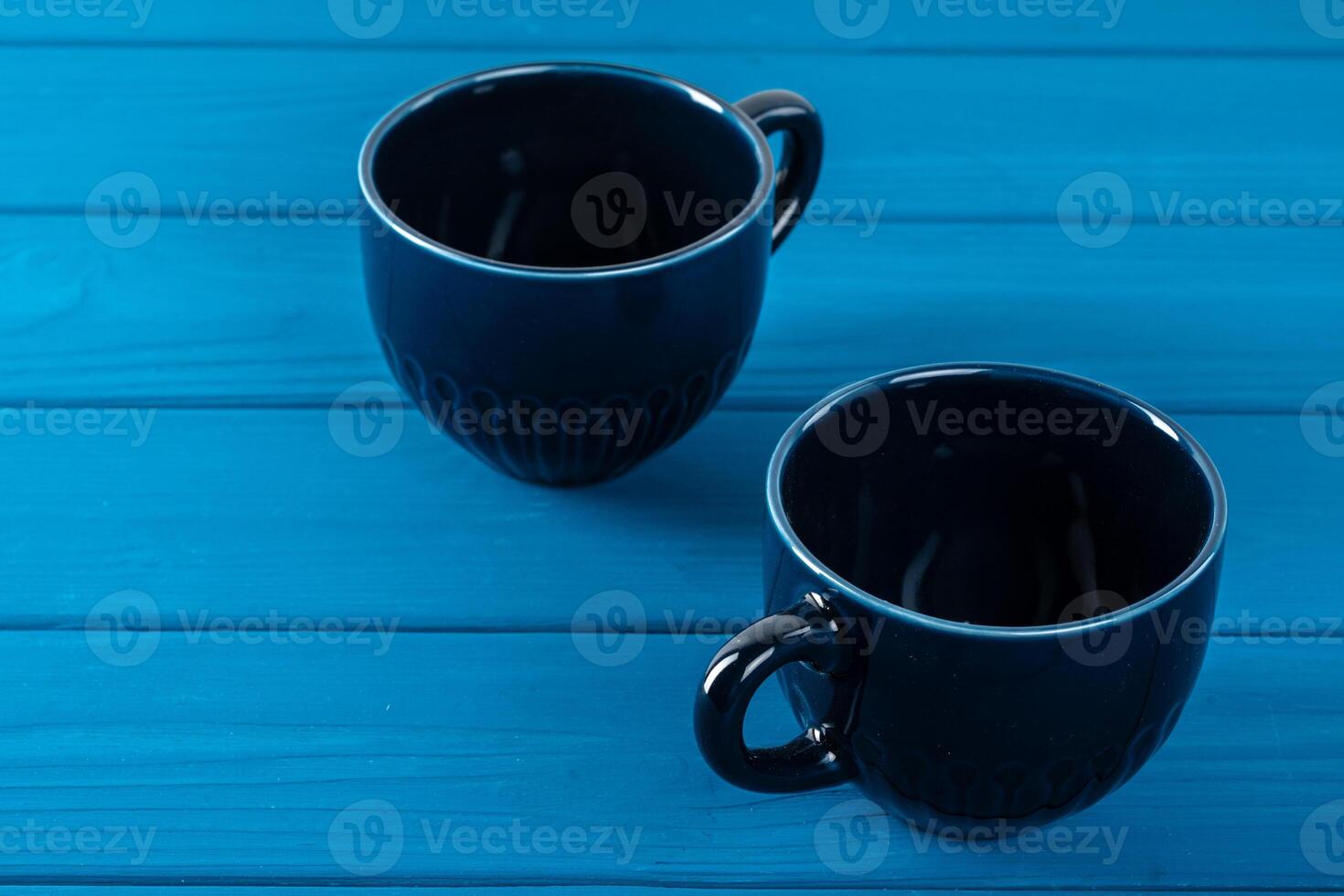 Dark blue ceramic coffee cup on table photo