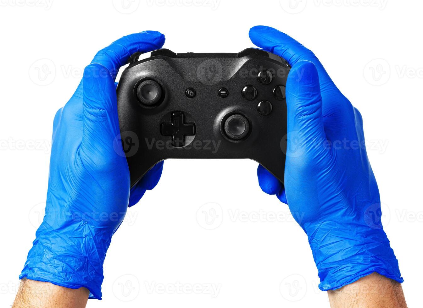 game console controller in gamer gloved hands. Games during isolation at home photo