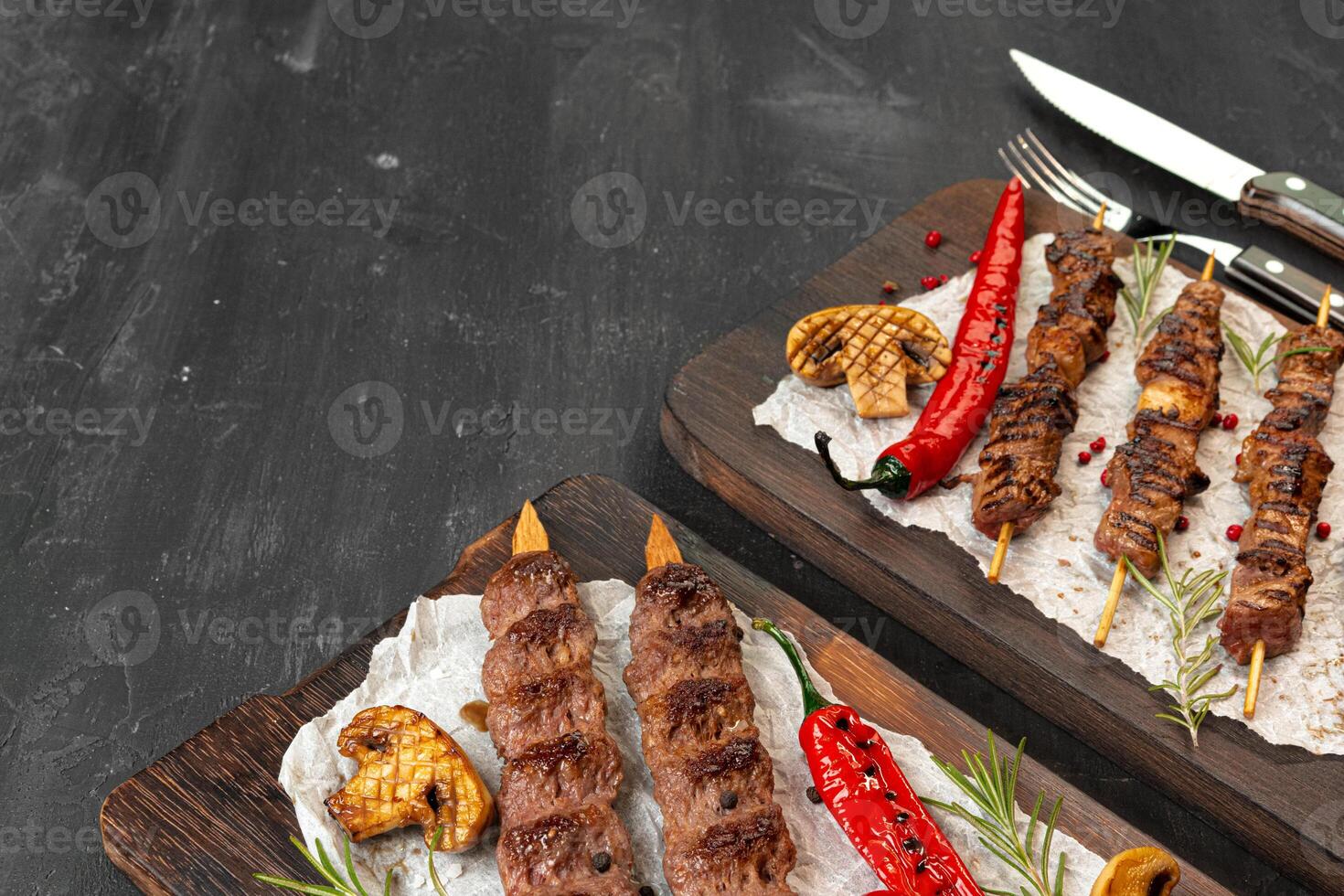 Grilled Lula kebab on skewers served on wooden board photo