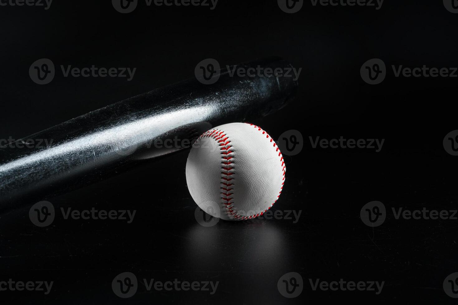 Baseball game equipment on dark black background photo