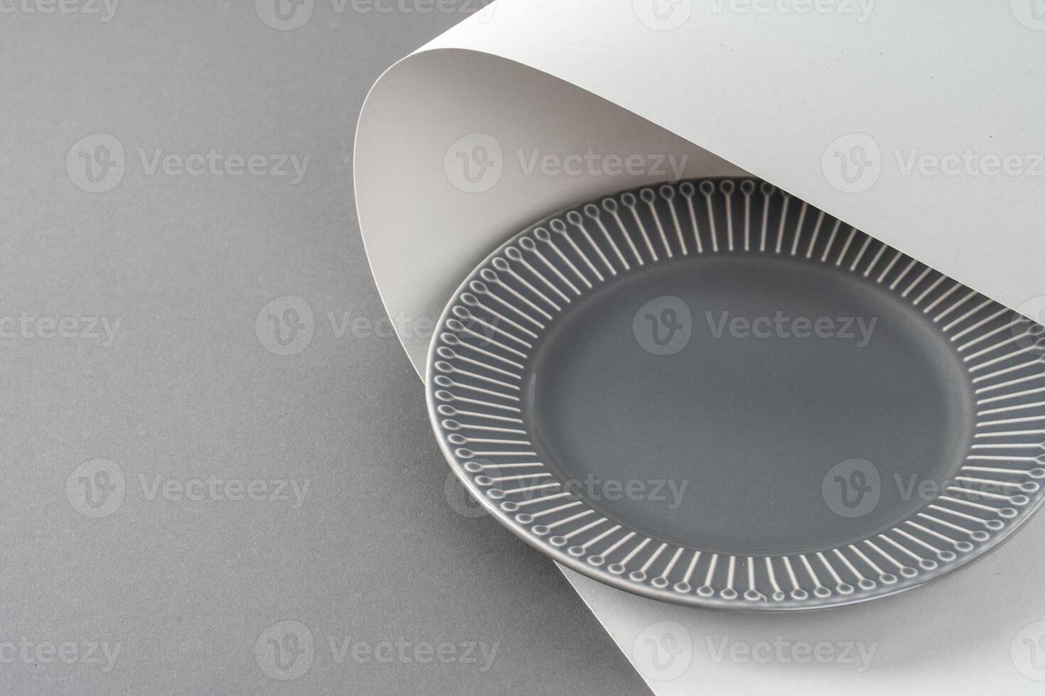 Glossy new ceramic dishware on paper background photo