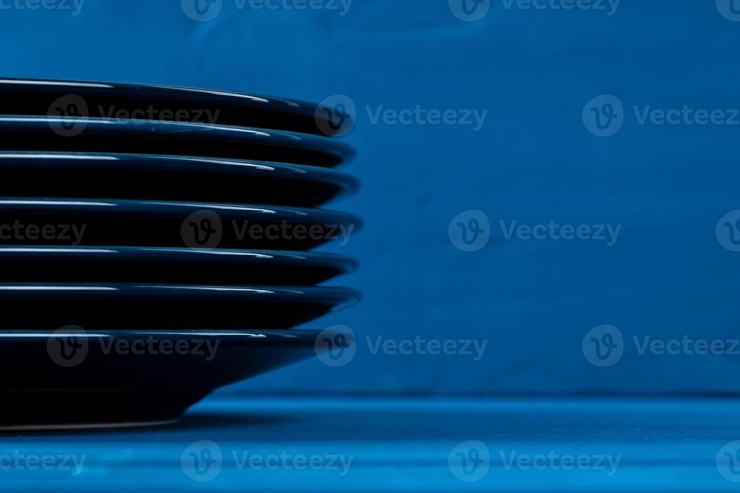 Dark blue crockery on blue wooden background photo