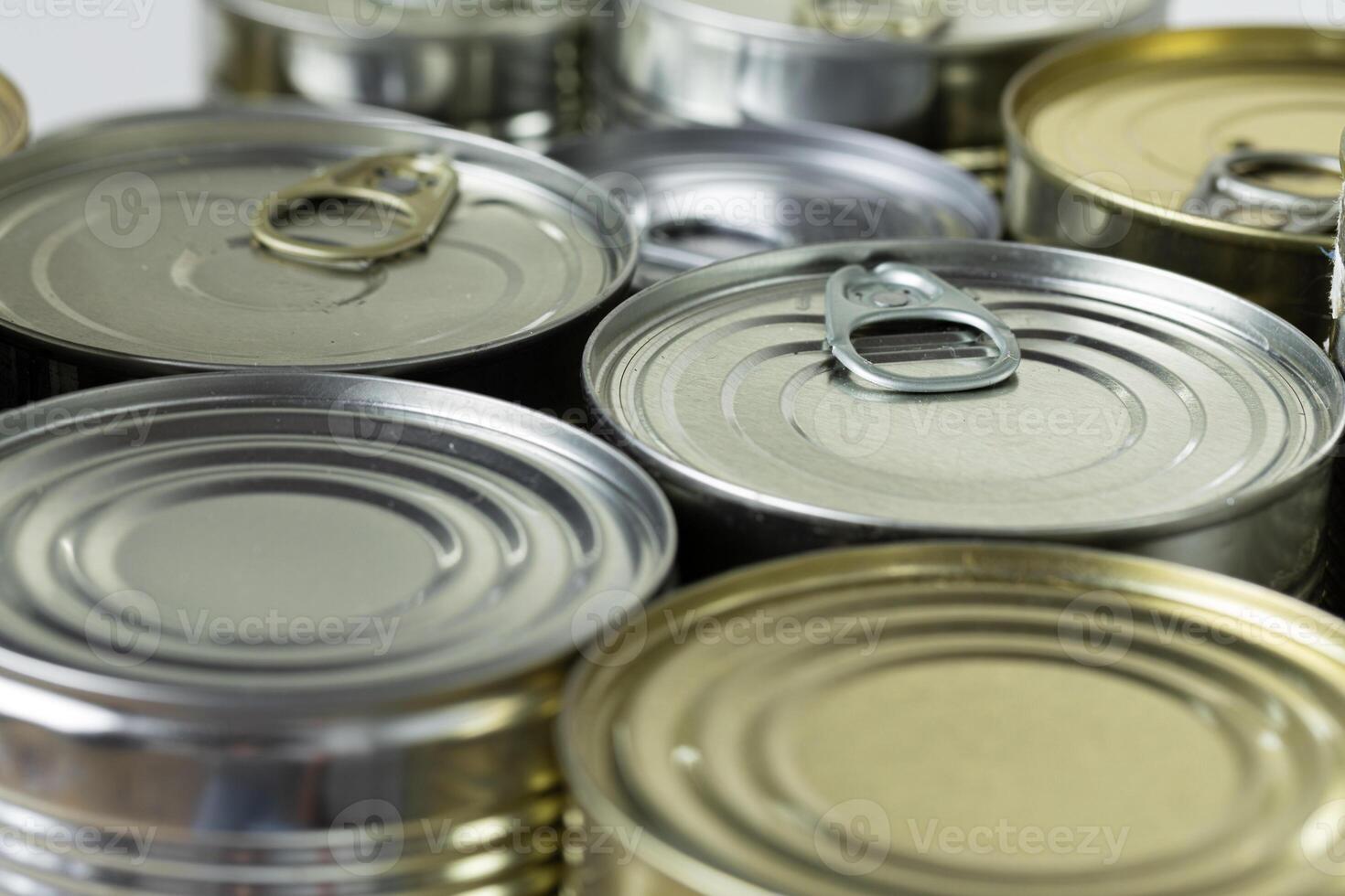 many cans with meals such as meat and fish on the table, conserved food photo