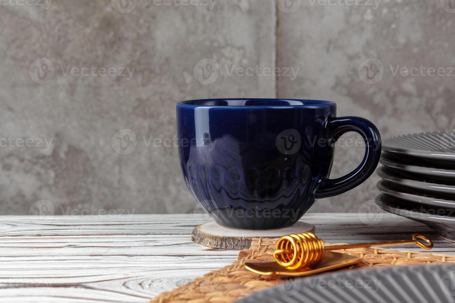 Still life photo of empty tea cup with honey spoon