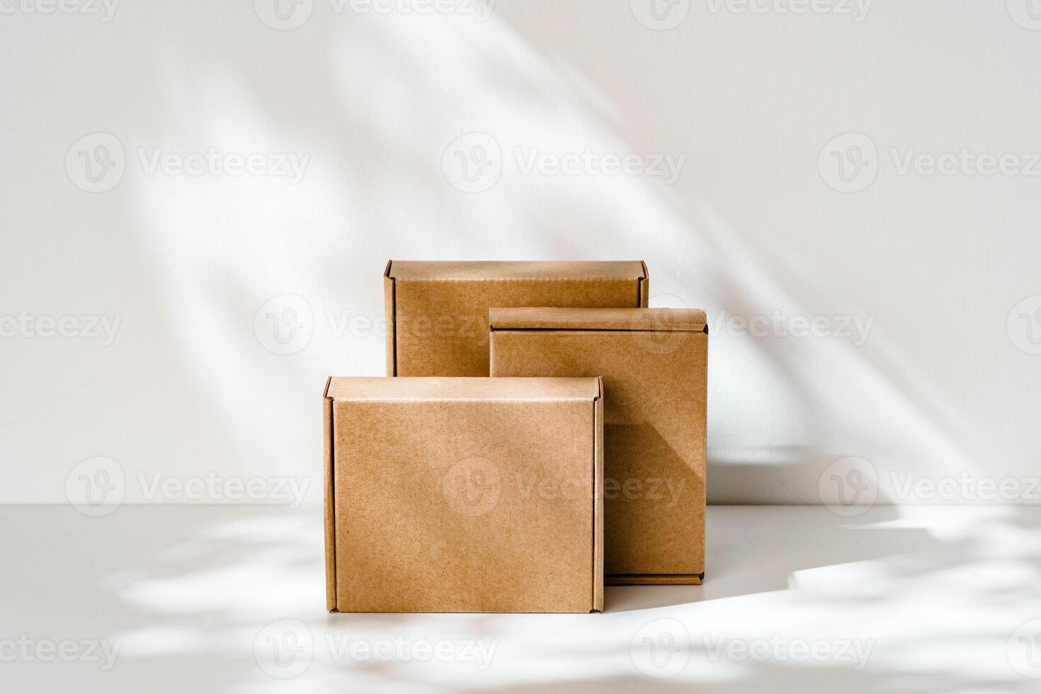 Freshly packed cardboard boxes resting on a white surface, illuminated by soft natural light photo