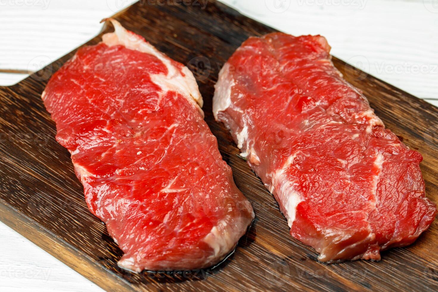 Close up of fresh uncooked rib eye steak photo