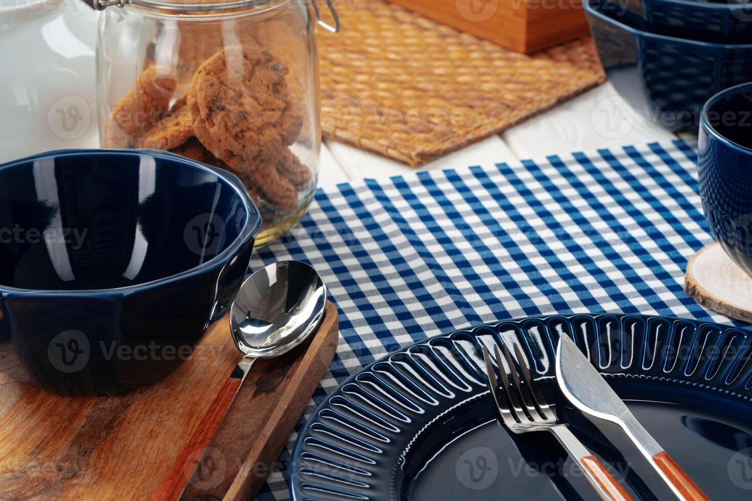 Deep blue ceramic plate with cutlery close up photo