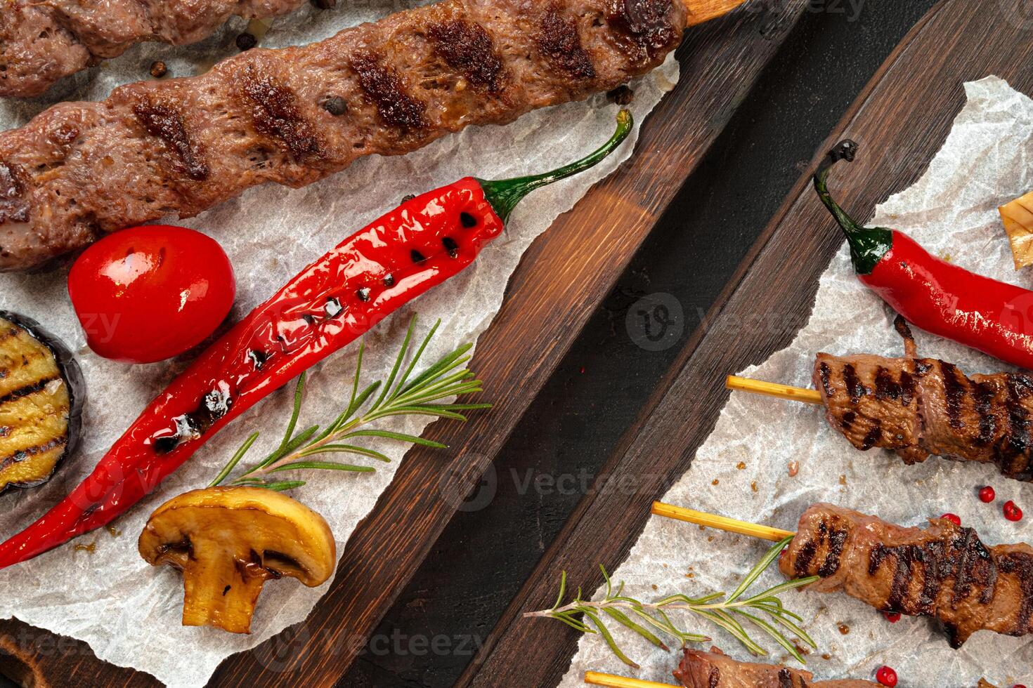 Grilled Lula kebab on skewers served on wooden board photo