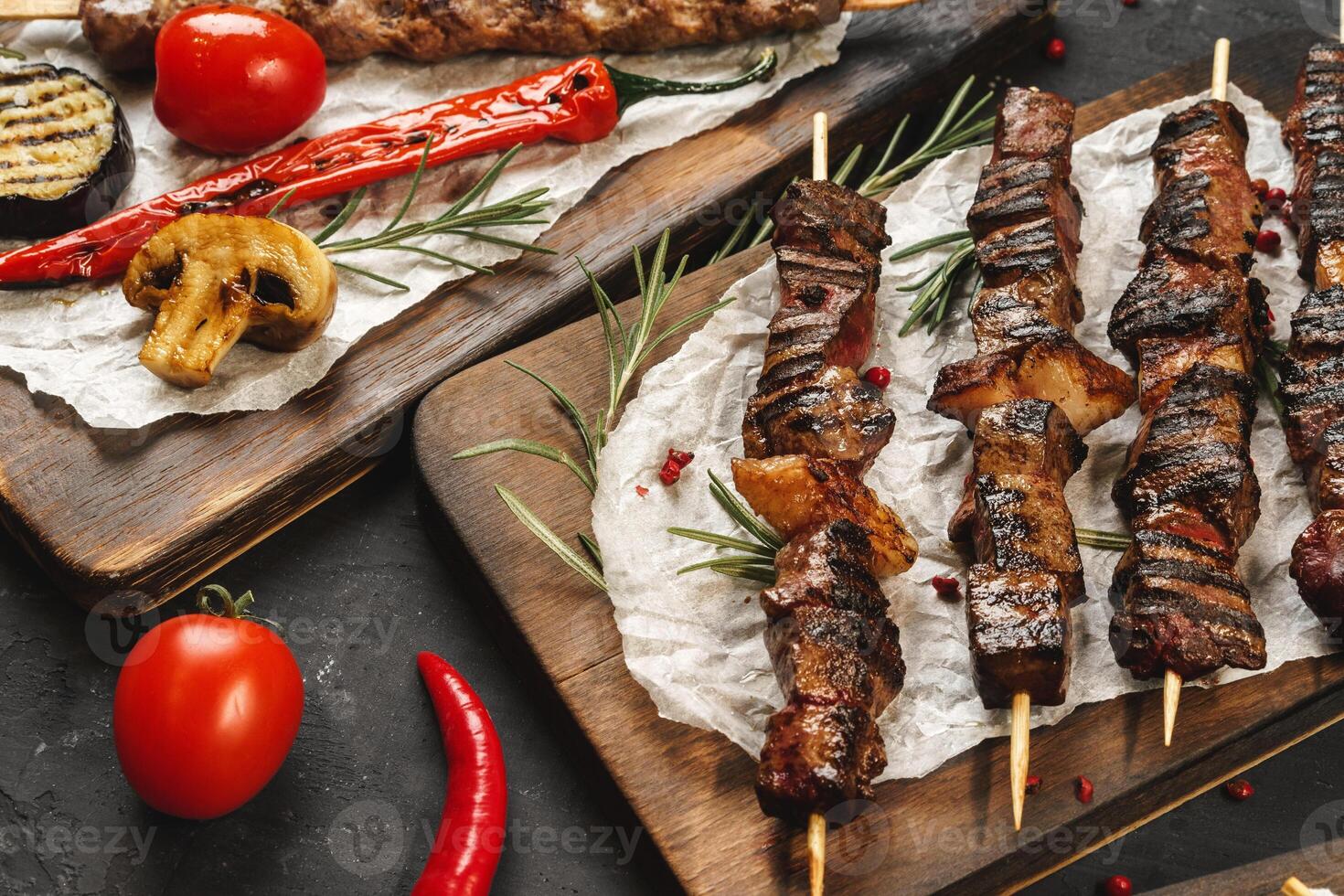 Grilled meat skewers barbecue served on board photo