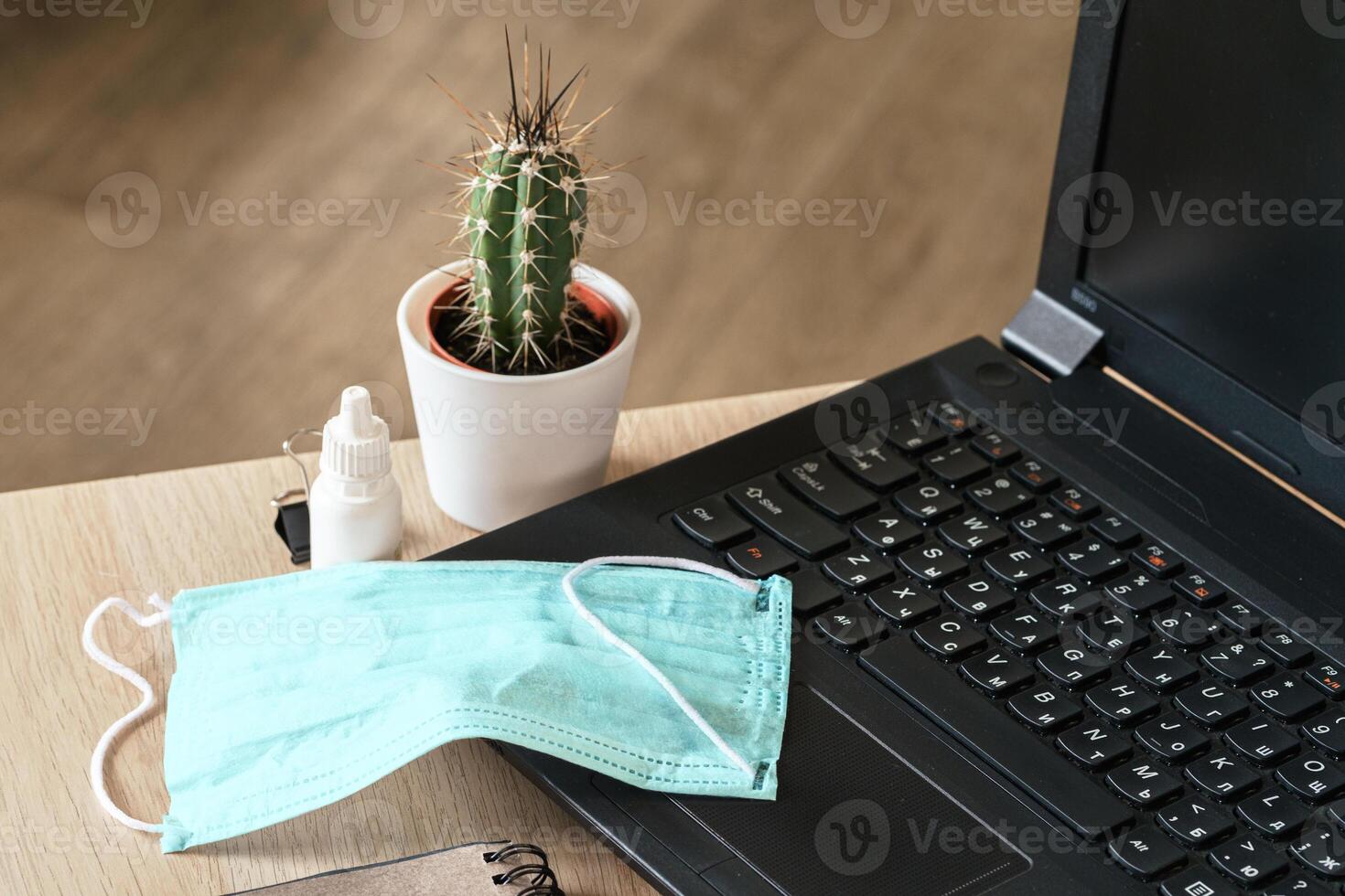 Medical protective mask on office table. Coronavirus spread prevention concept photo