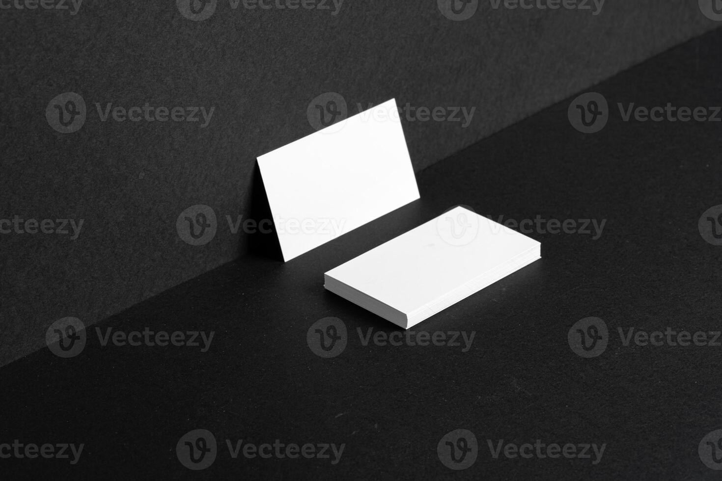 Stacked white businesscards for branding identity on black background photo