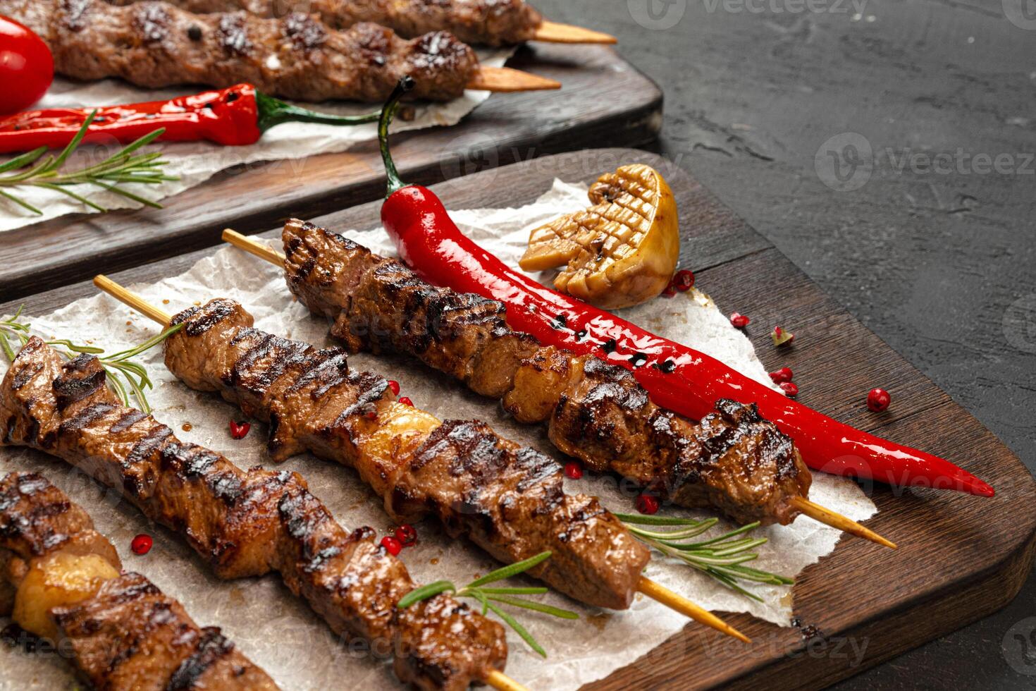 Grilled meat skewers barbecue served on board photo