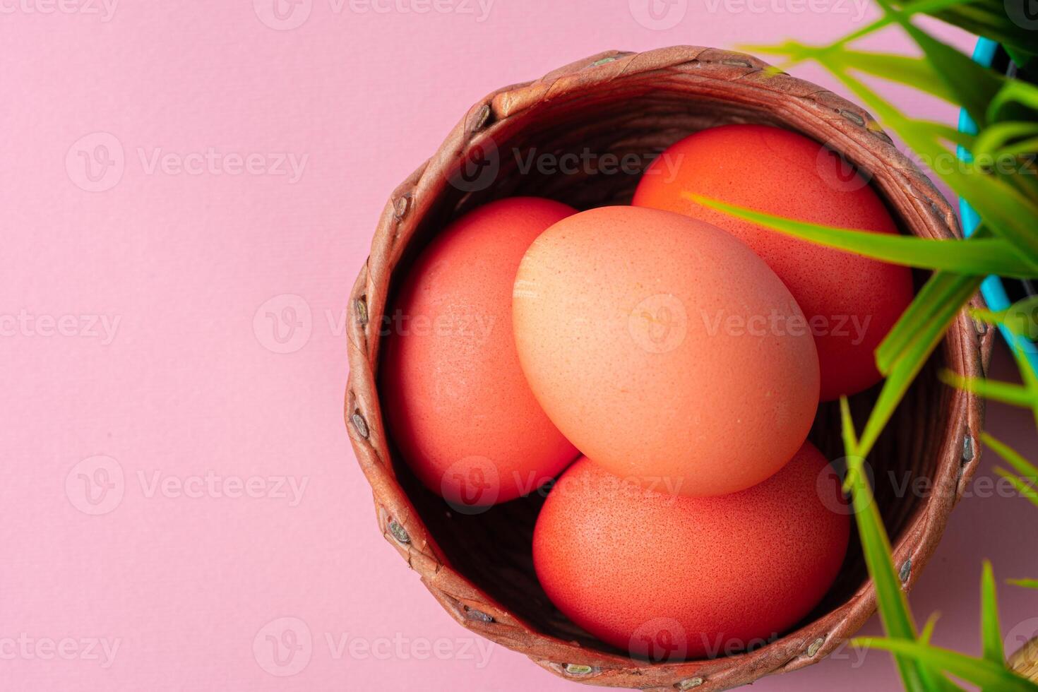 Colored eggs for Easter with pot of artificial grass photo