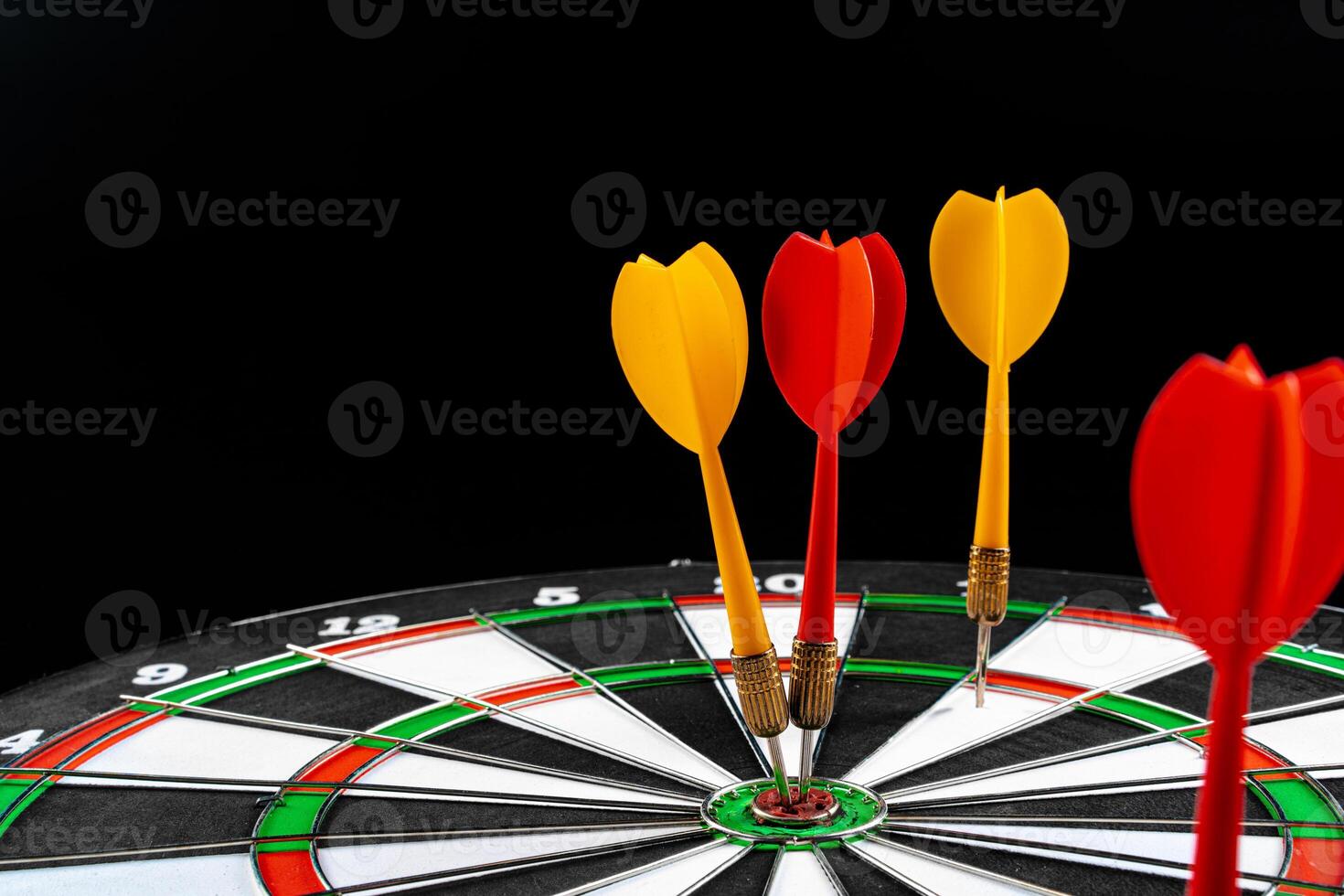 Dartboard on black dark background close up photo