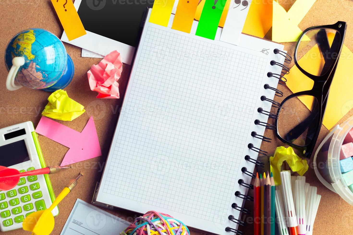 Desk of an artist with lots of stationery objects photo