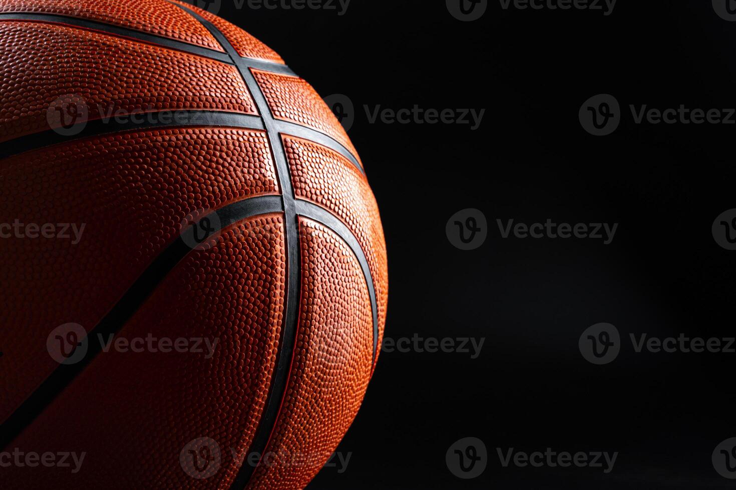 Basketball ball close up on dark black background photo