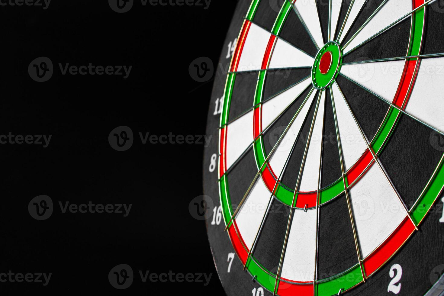 Dartboard on black dark background close up photo