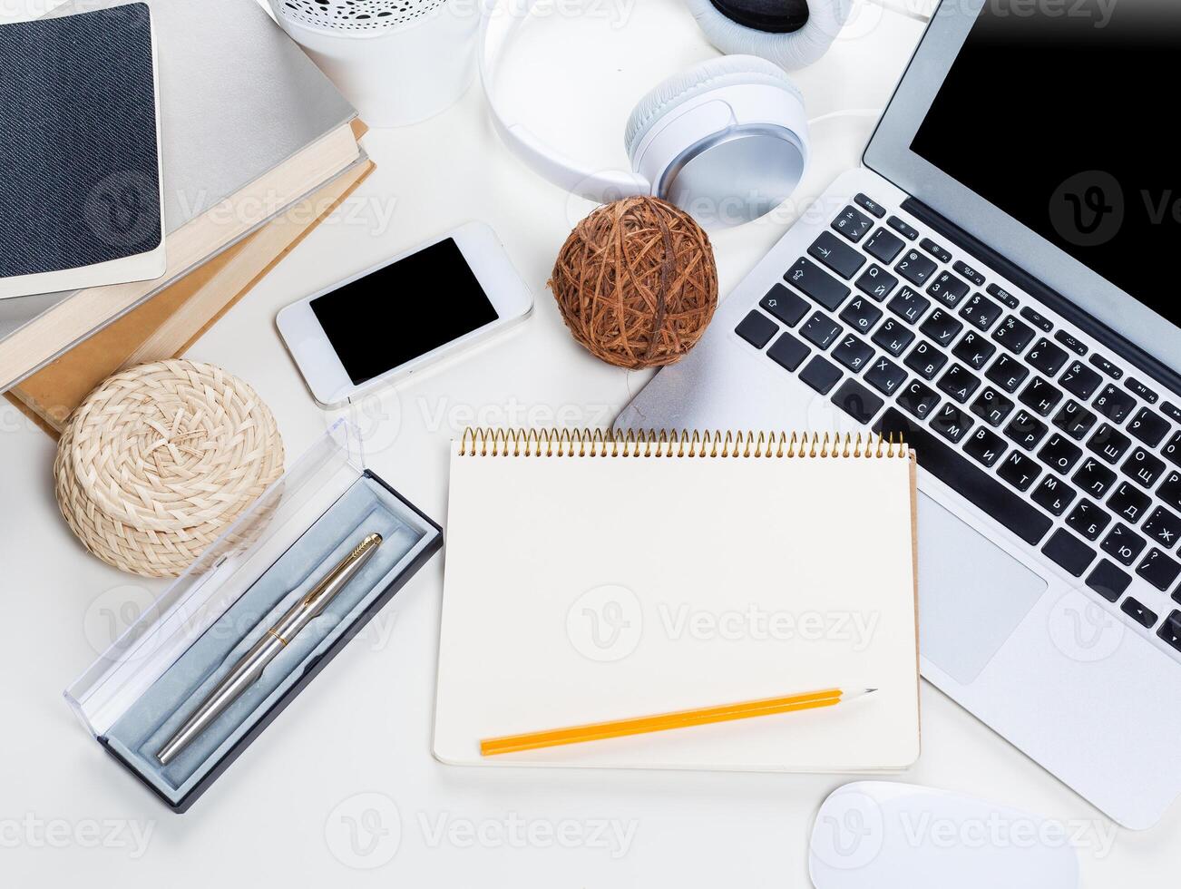 White office desk table with a lot of things on it. Top view photo