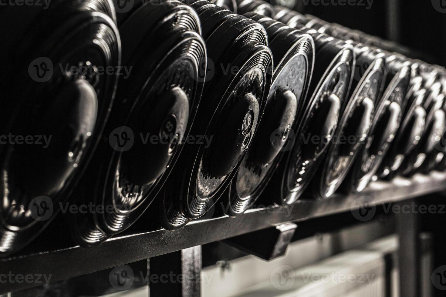 Sports equipment in gym. Dumbbells of different weight close up photo