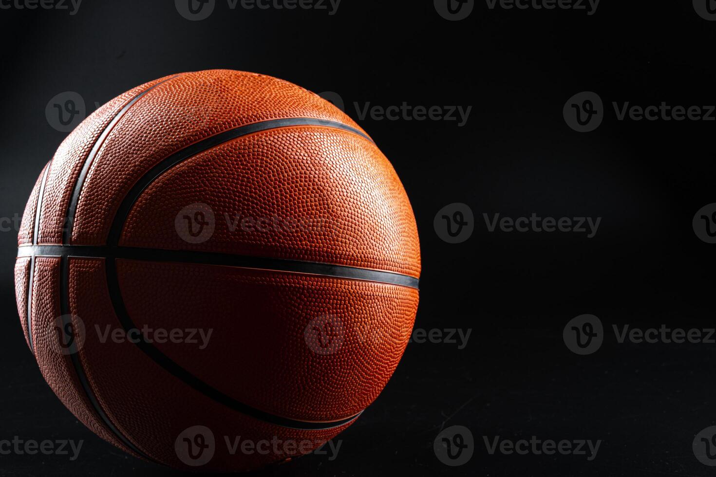 Basketball ball close up on dark black background photo