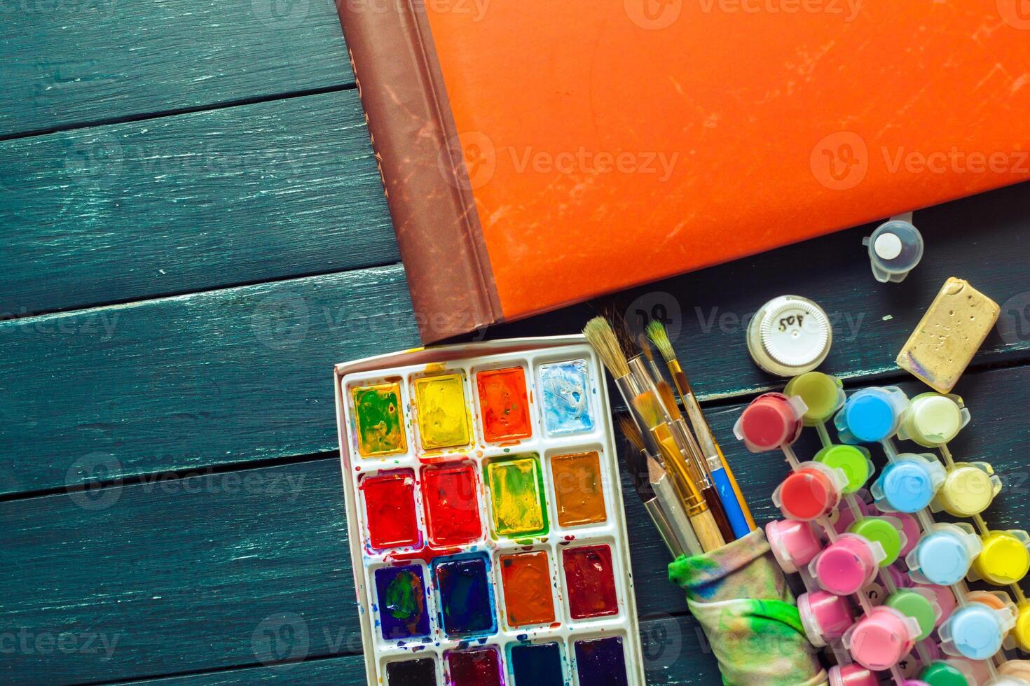 Set of watercolor paints and paintbrushes for painting photo