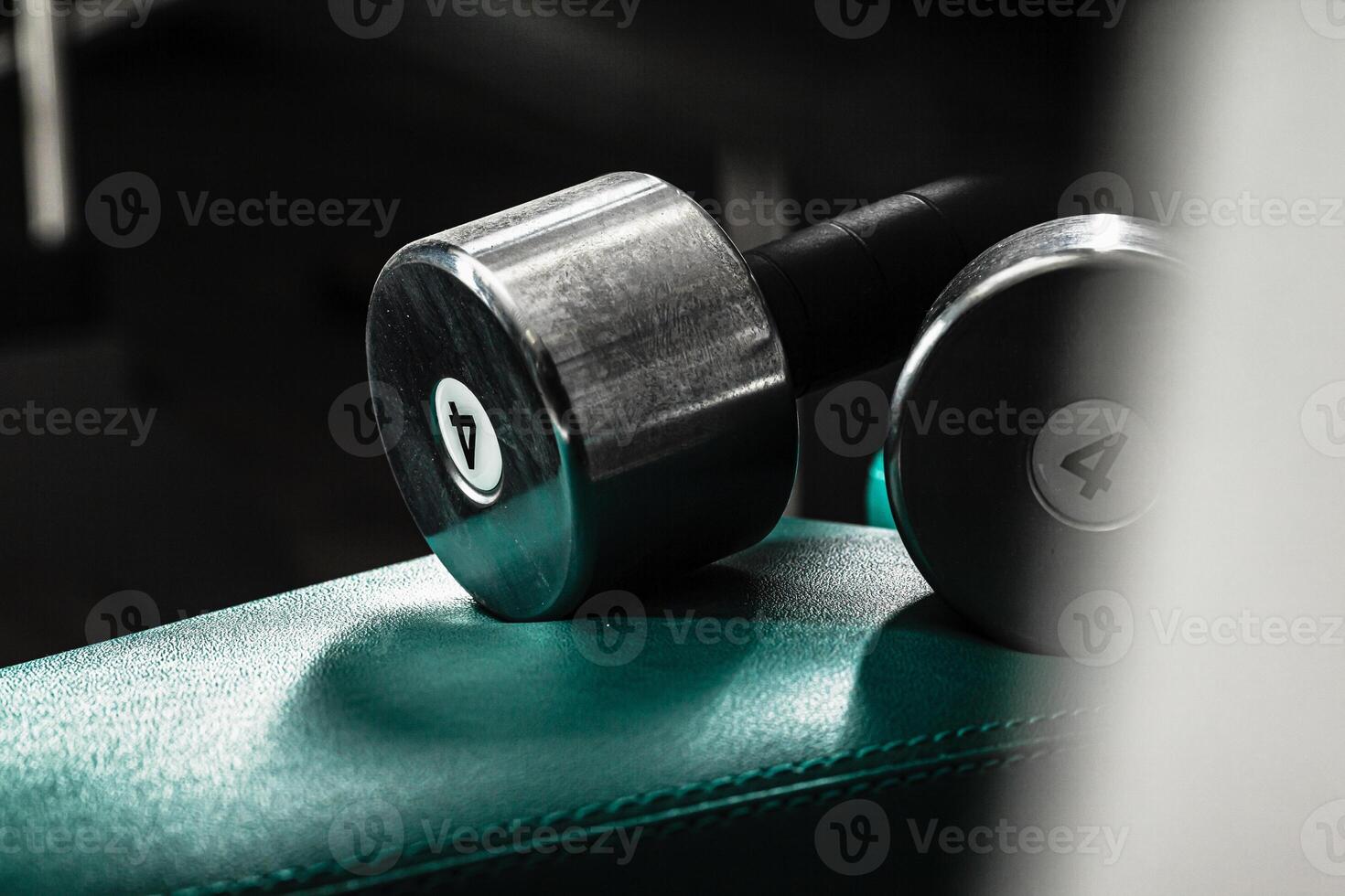 Sports equipment in gym. Dumbbells of different weight close up photo