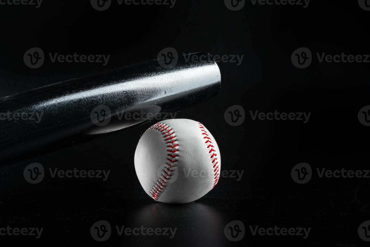 Baseball game equipment on dark black background photo