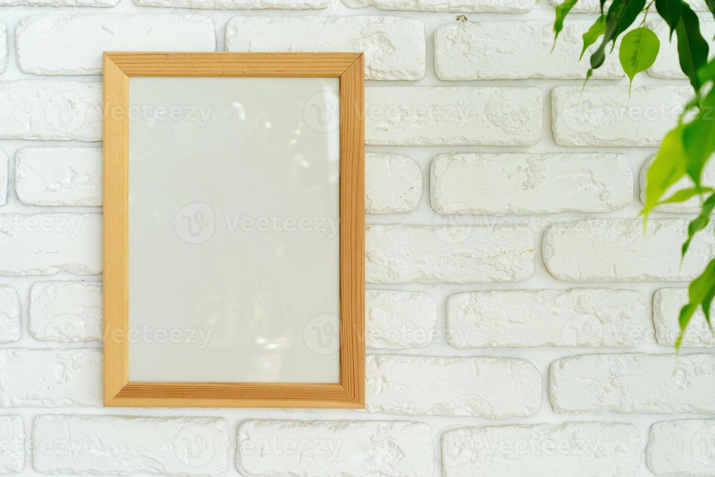 House plant leaves against white brick wall with copy space photo