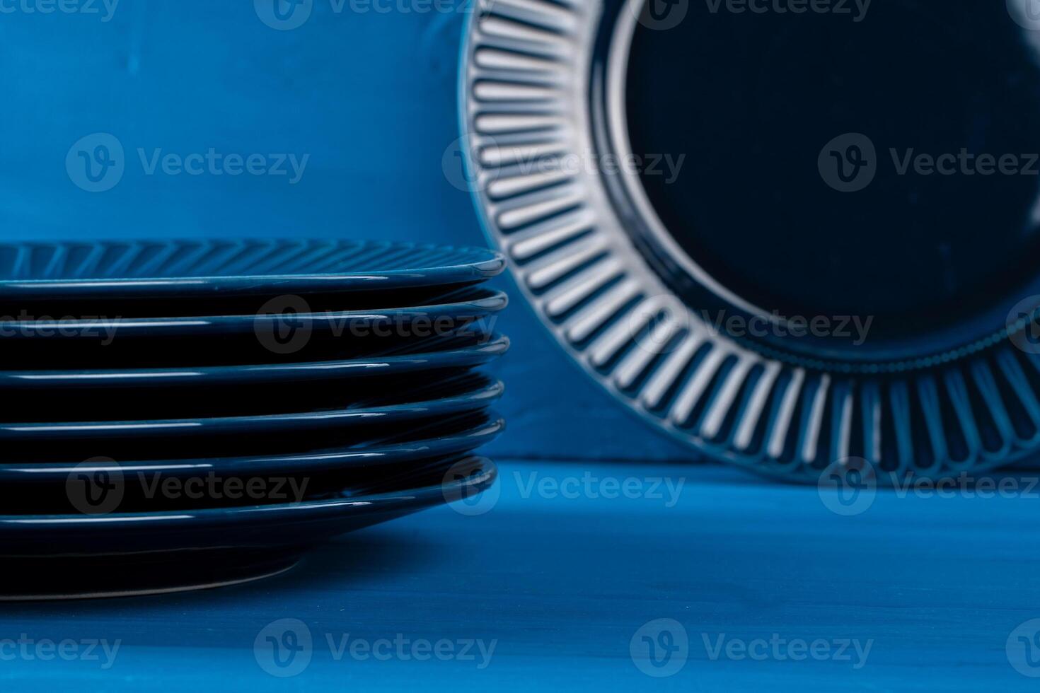 Dark blue crockery on blue wooden background photo