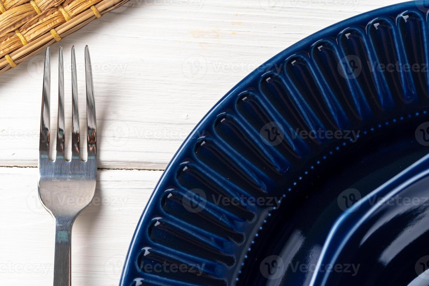 Classic blue ceramic tableware on checkered tablecloth photo