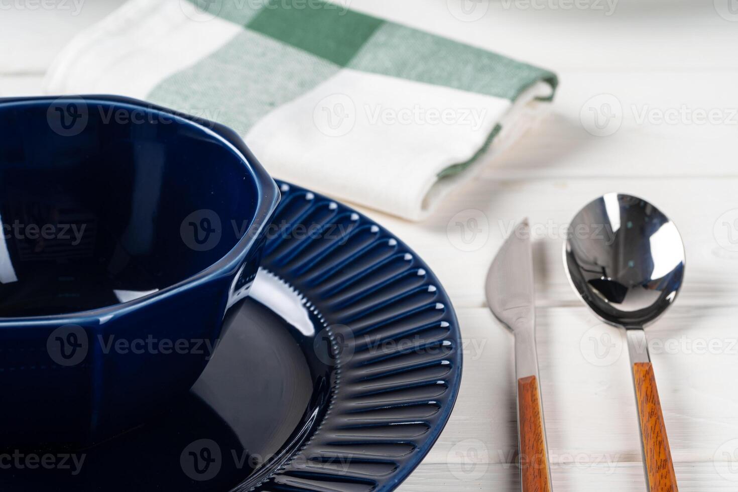 Classic blue ceramic tableware on checkered tablecloth photo