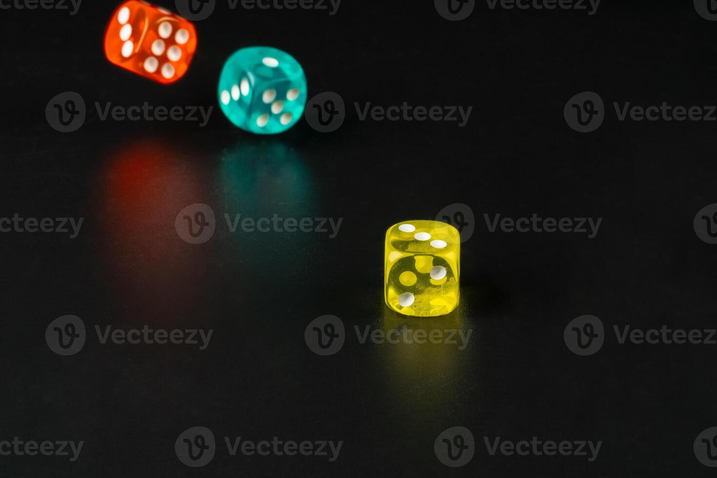 Group of dice close up on dark black background photo