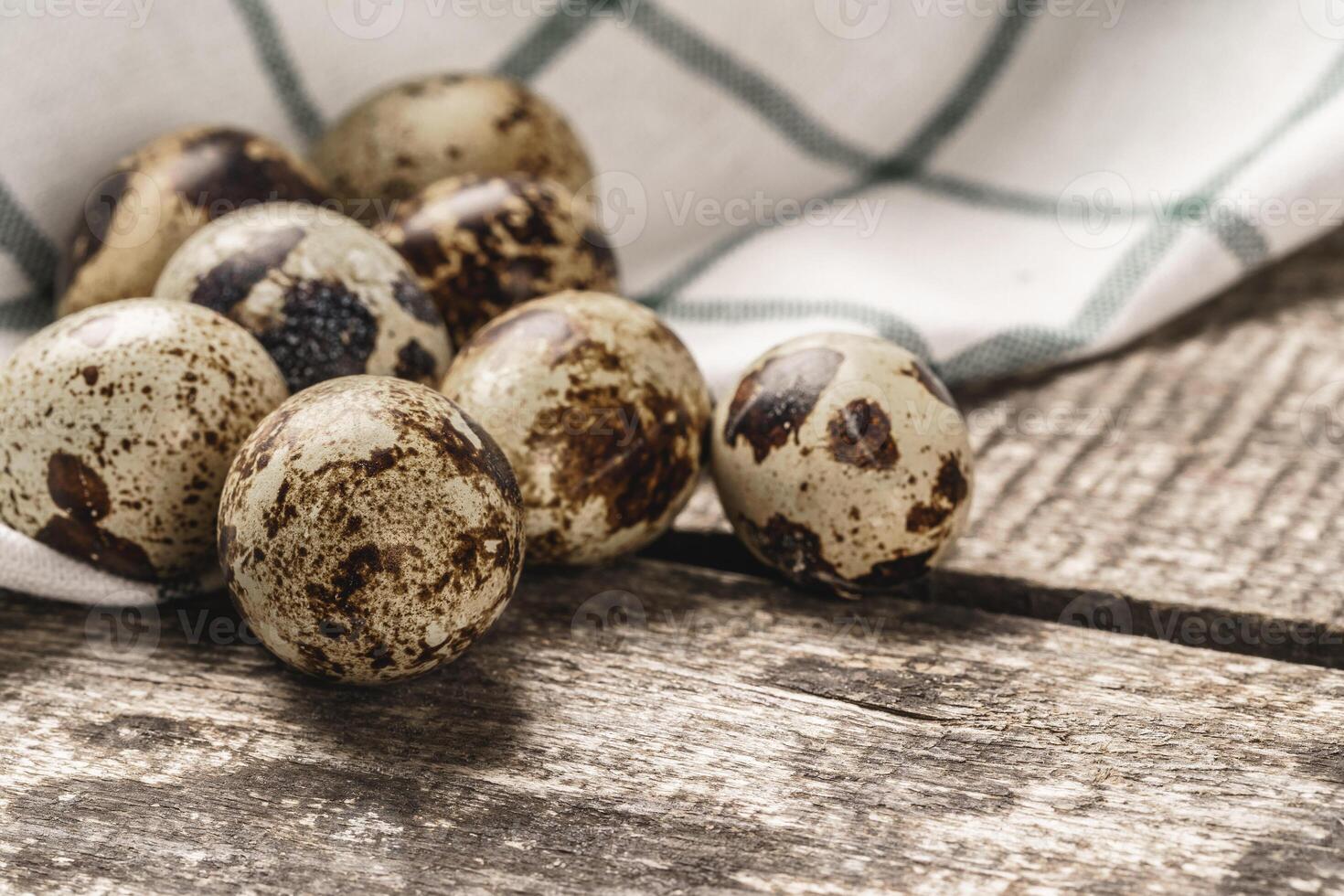 Quail eggs on a wooden table photo