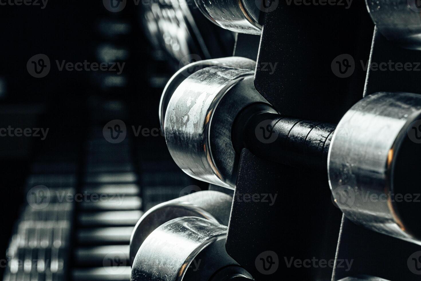 Sports equipment in gym. Dumbbells of different weight close up photo