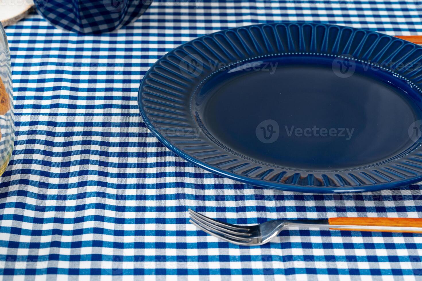 Classic blue ceramic tableware on checkered tablecloth photo