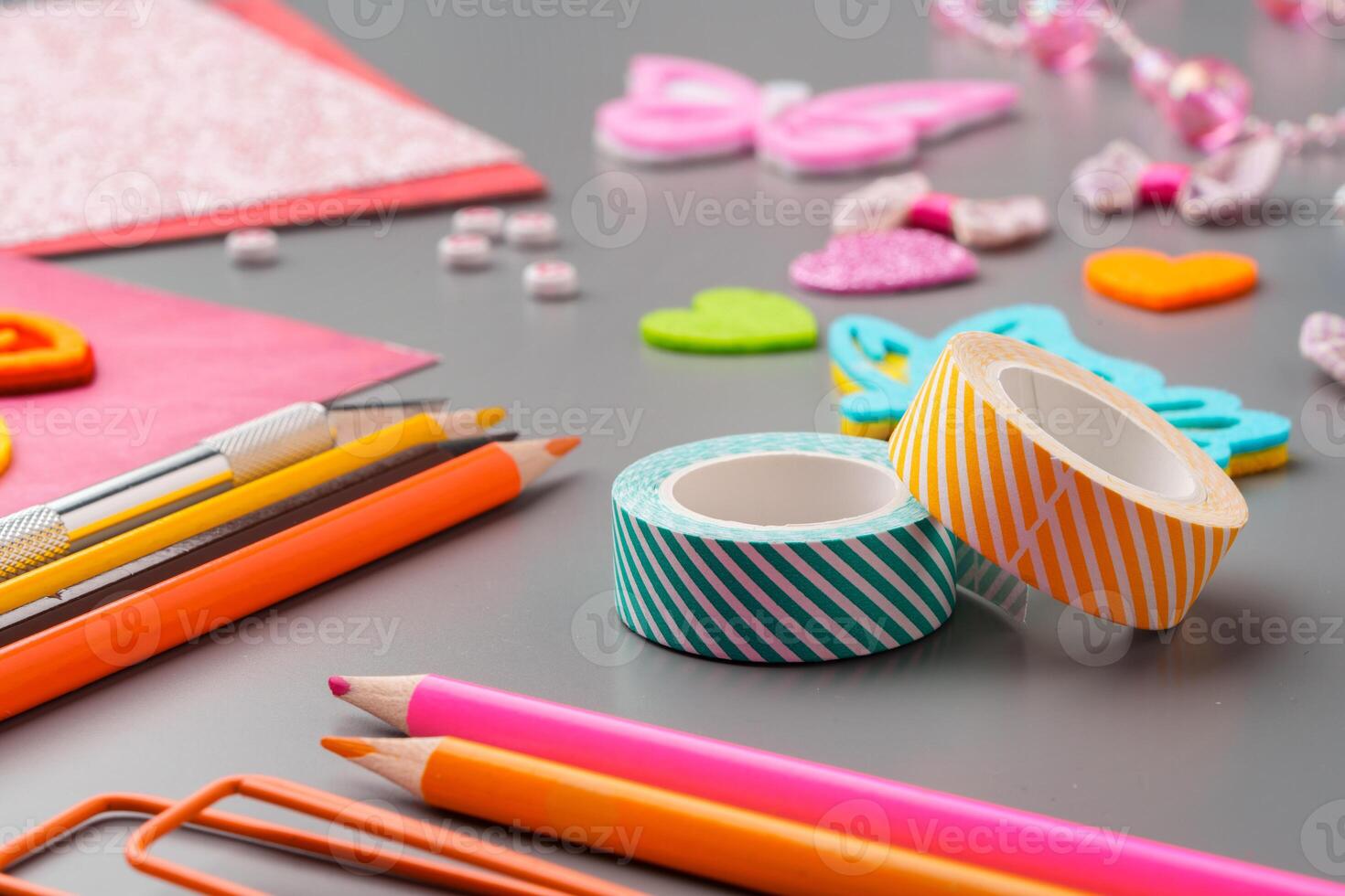 Crafting materials and tools arranged on a gray surface during a creative project photo