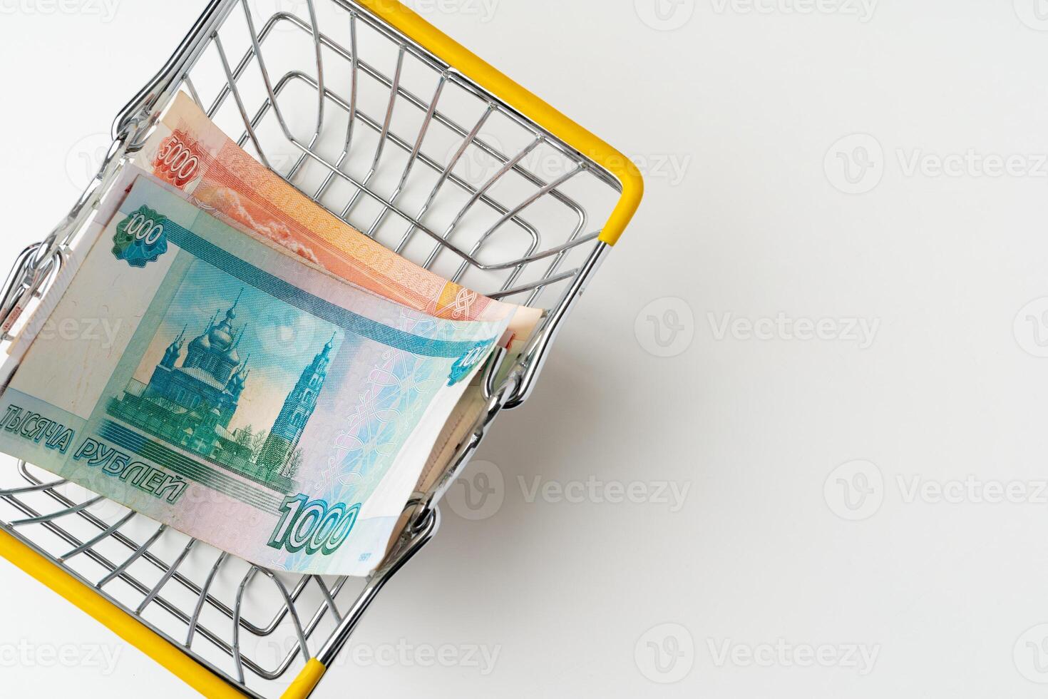 Toy shopping cart with Russian rubles money. Living wage and purchasing power concept photo