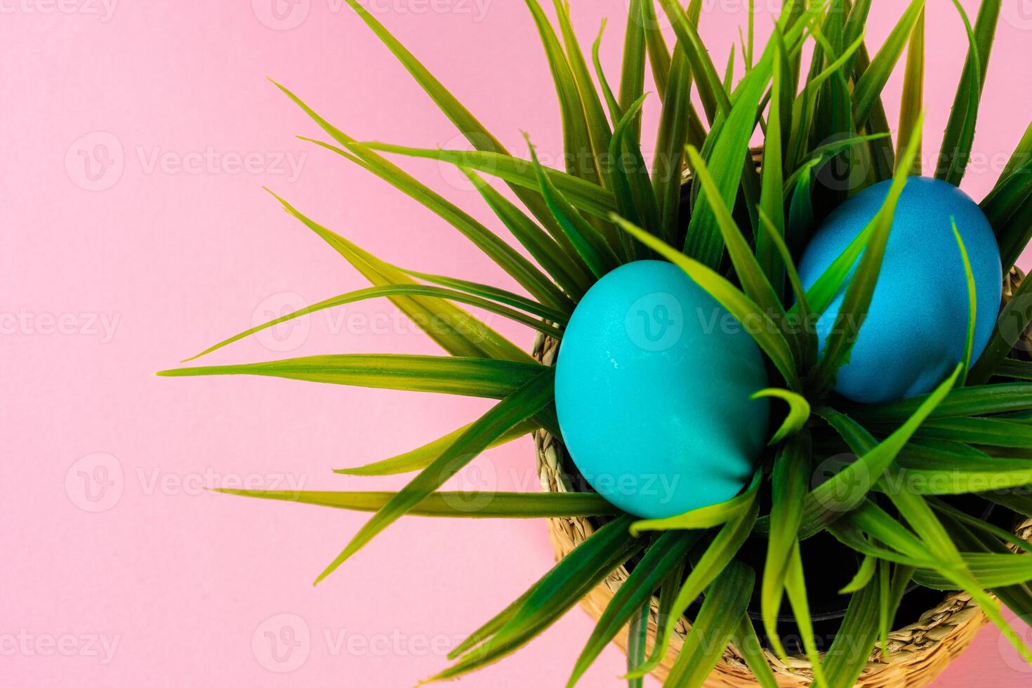 Colored eggs for Easter with pot of artificial grass photo