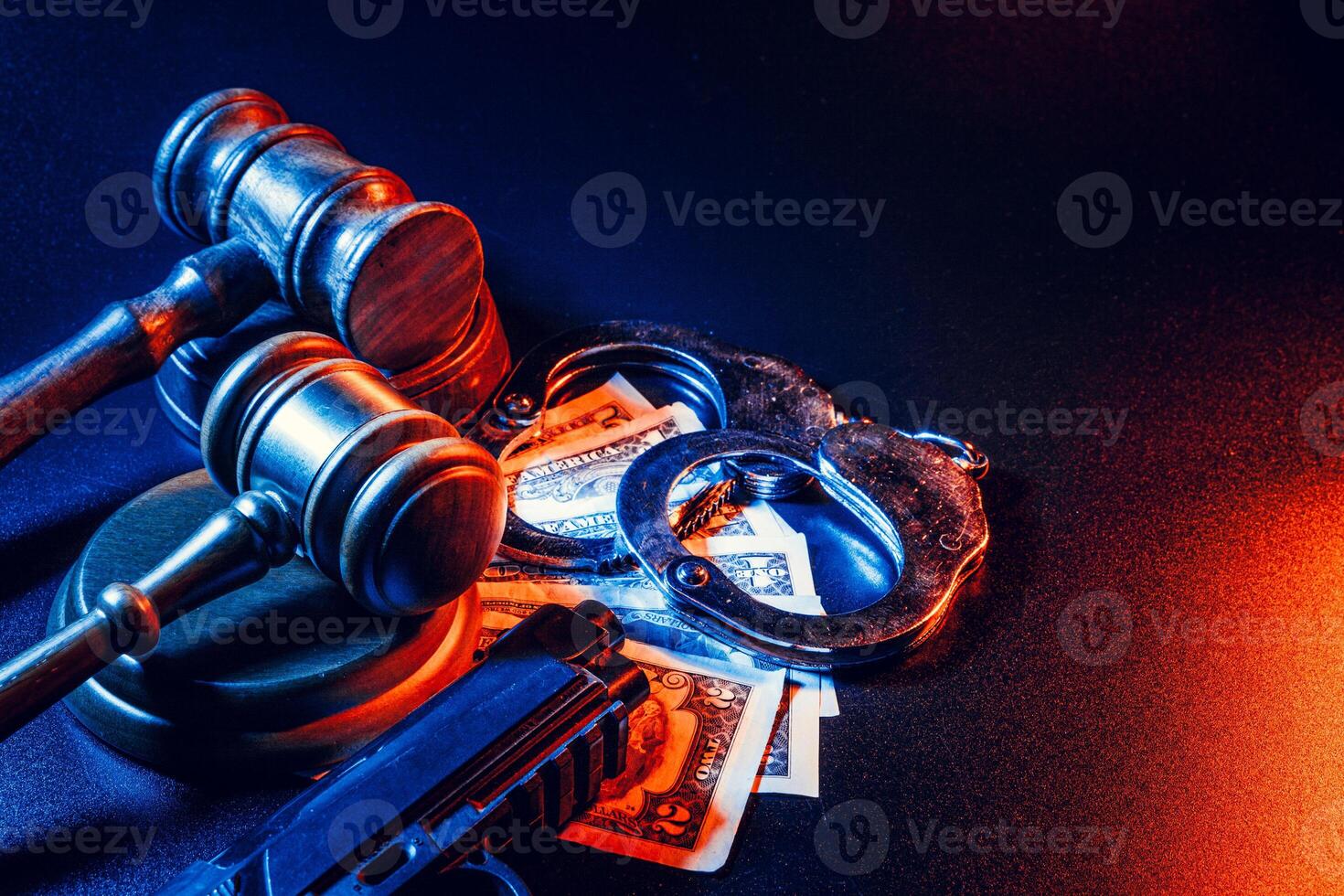 Gun and judge's gavel on the table. Crime, robbery, attack concept photo