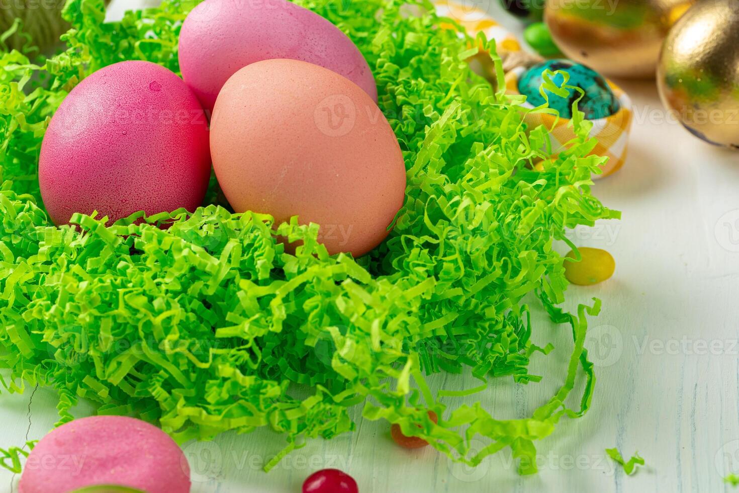 Colofrul Easter eggs and scattered candies on wooden table photo