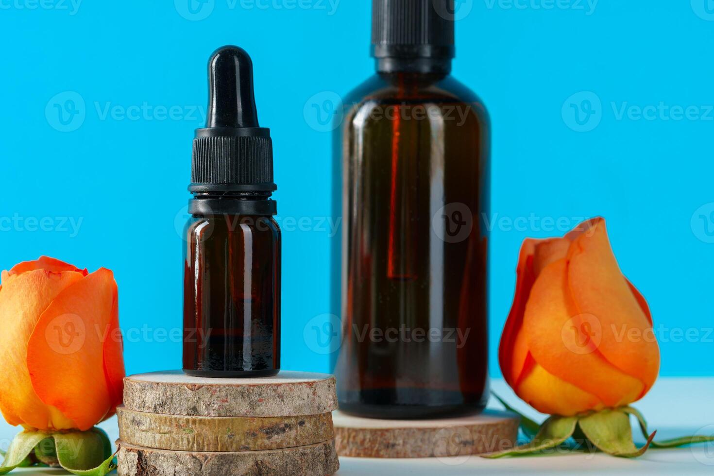 Cosmetics containers decorated with orange rose petals photo