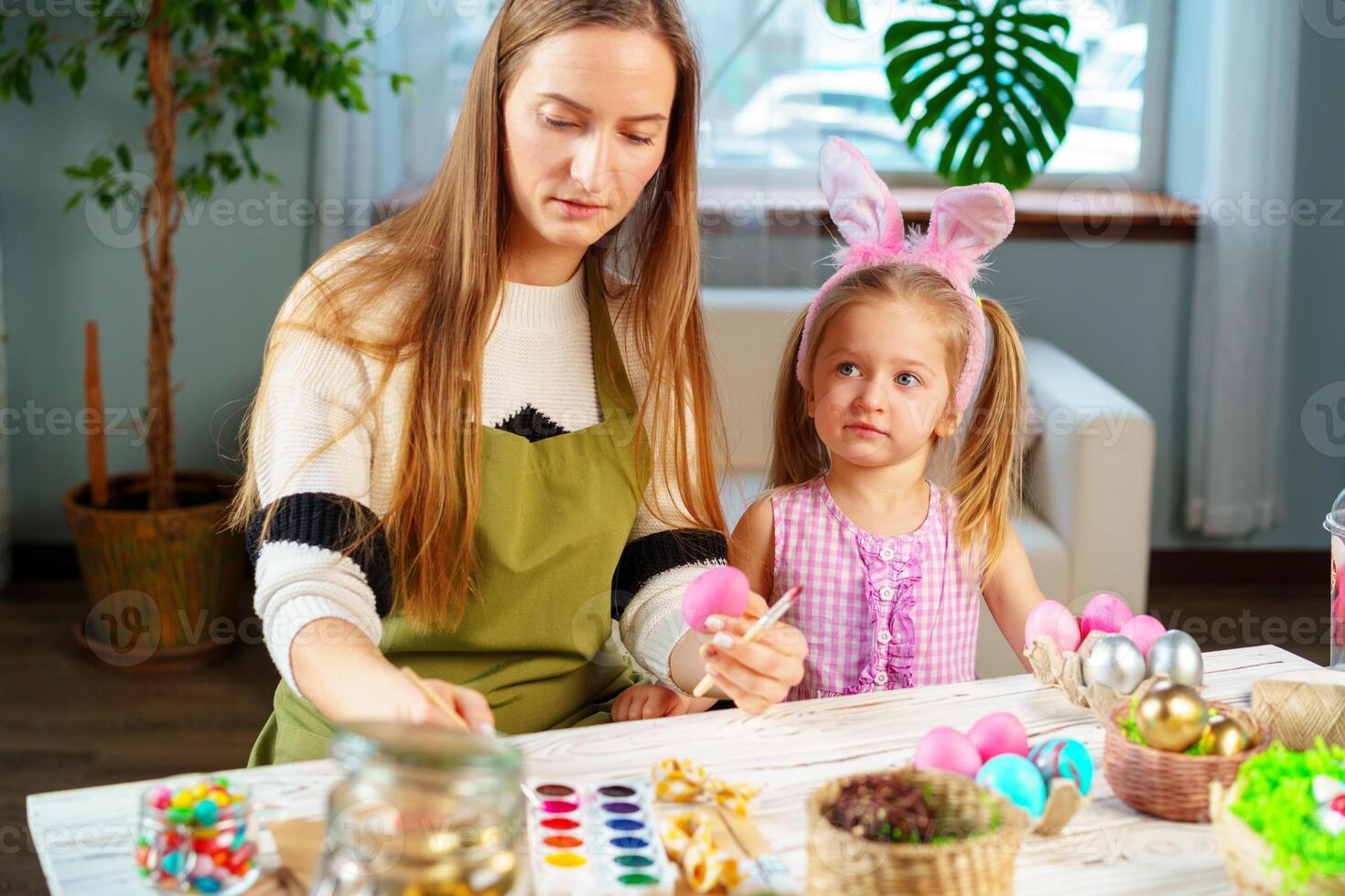 Cute family, mother and daughter preparing for Easter celebration photo