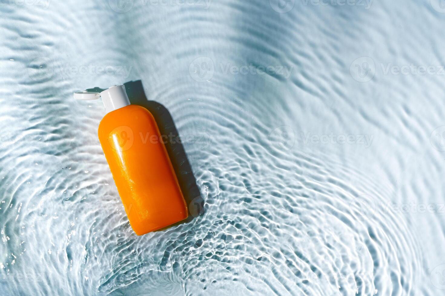 Tropical setting with a skincare tube resting on textured white surface illuminated by sunlight photo
