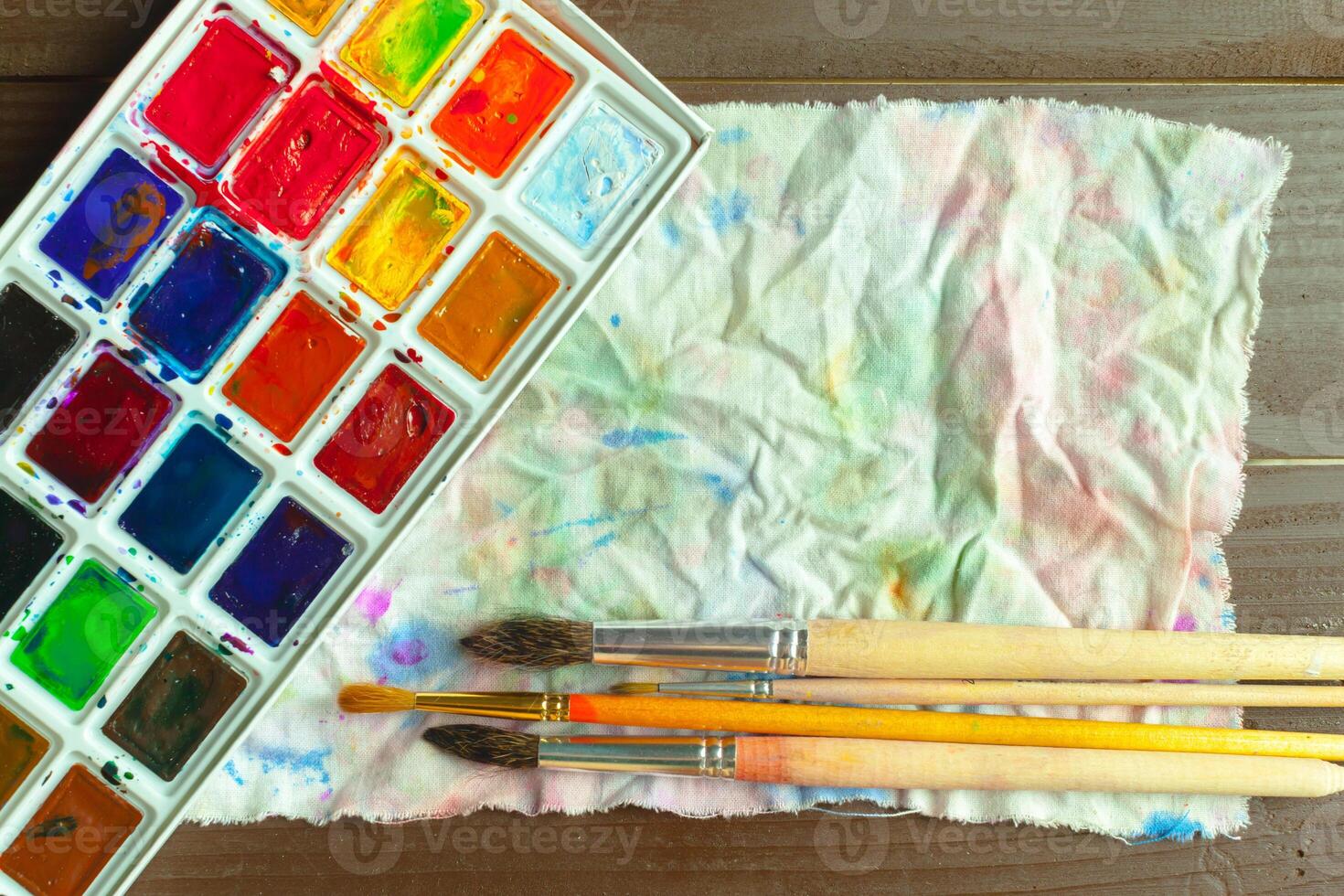 Set of watercolor paints and paintbrushes for painting photo