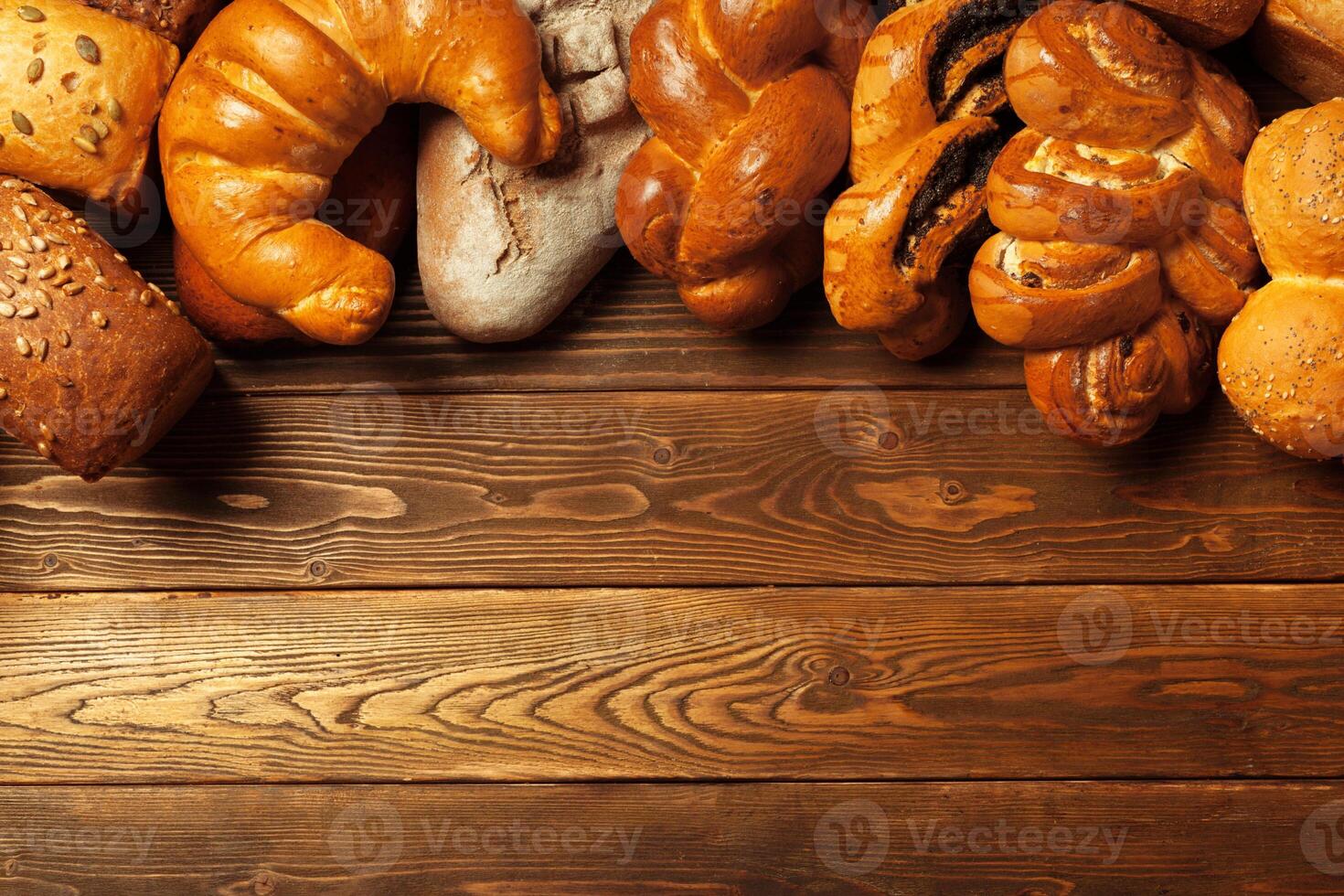 Freshly baked bread on wooden table photo