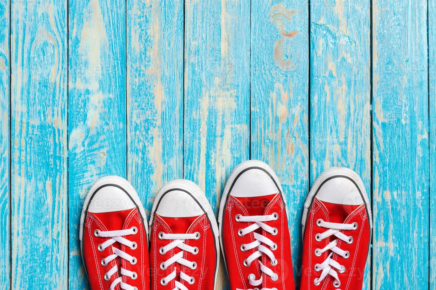 red sneakers on wooden background. photo