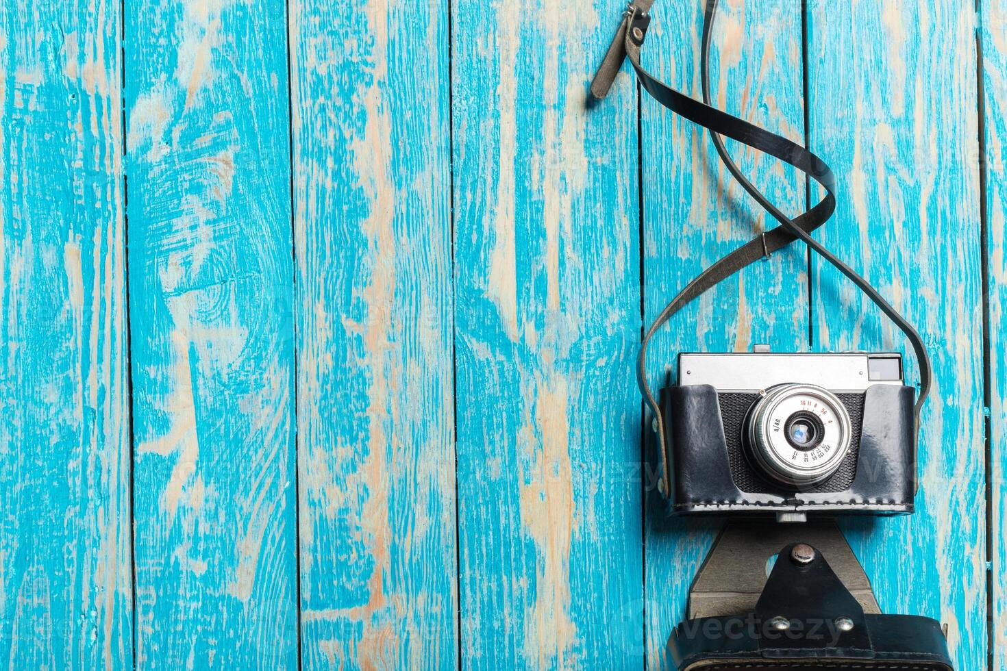 Old retro camera on wooden table background photo