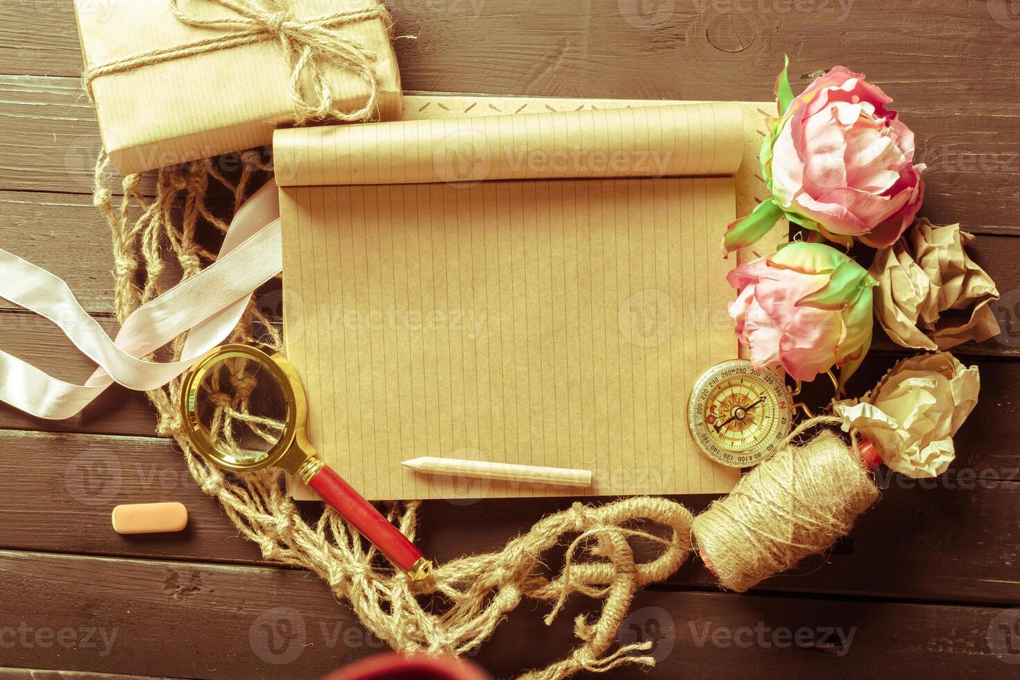 flowers and a notebook on wooden background photo